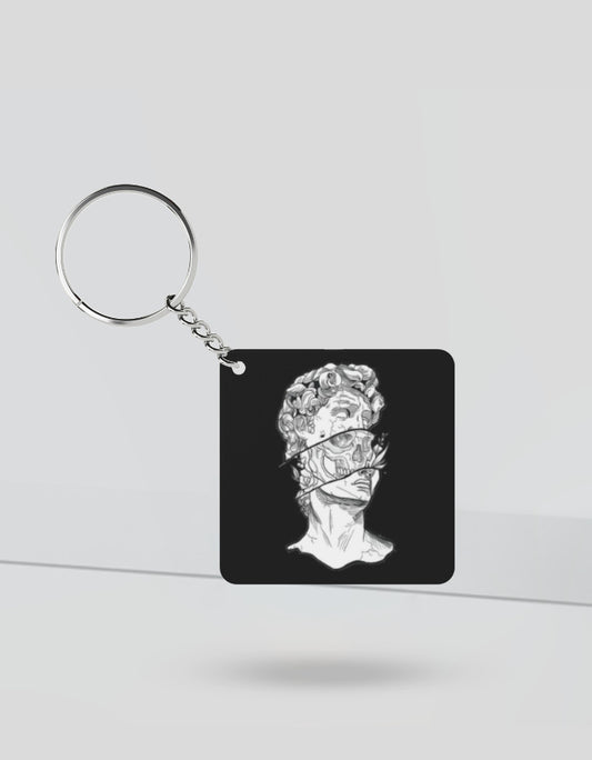 Black square keychain with artistic bust sculpture design featuring gen z anime accessories