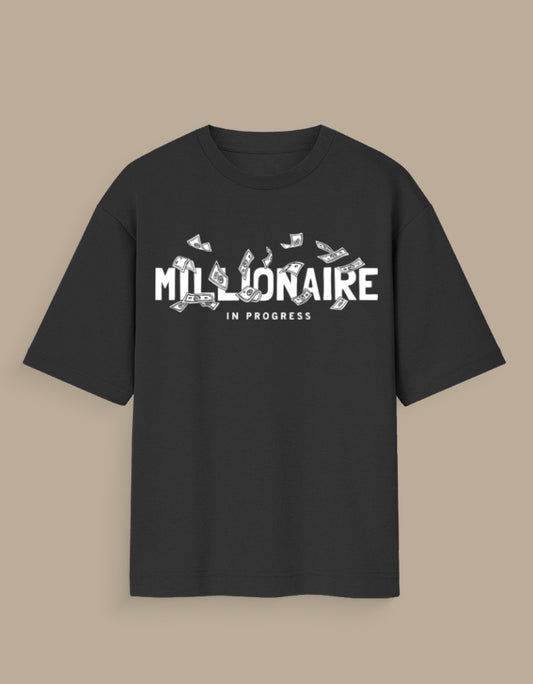 Black millionaire in progress tee with white text and flying money graphic on front