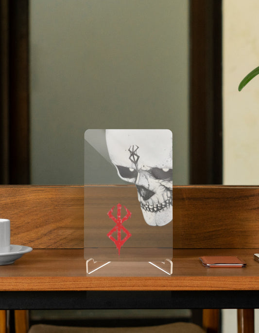 Berserk character relic collectible display on a wooden table with a coffee cup and smartphone