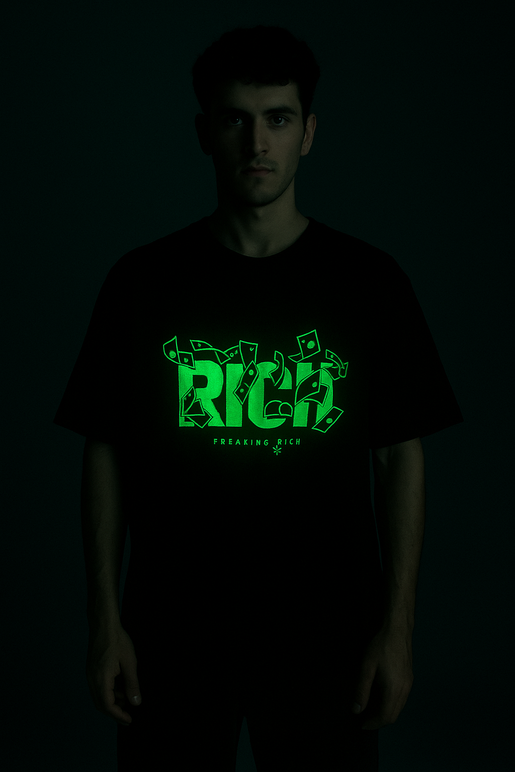 Black rich god anime aesthetic tee with glowing green graphic design on male model in dark background