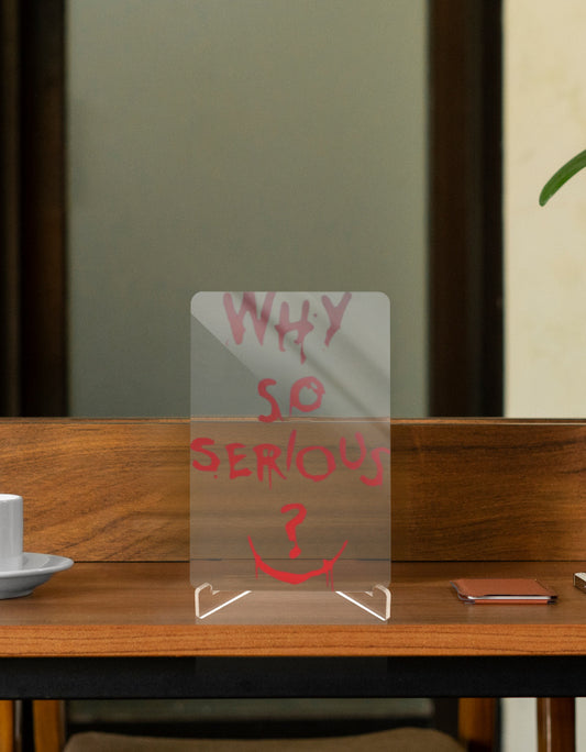 Joker character relic collectible with 'Why So Serious?' text on clear acrylic display
