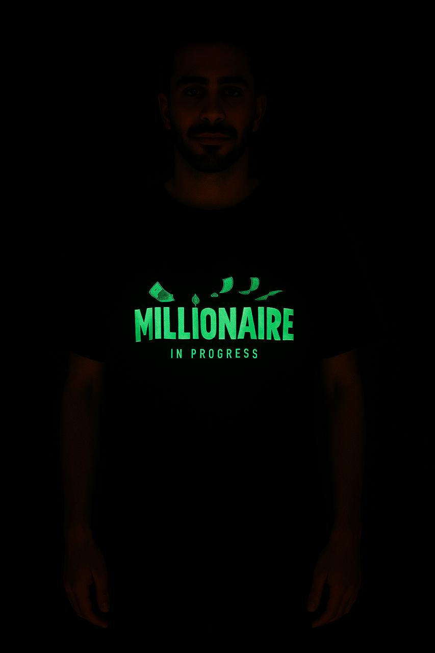 Glow-in-the-dark millionaire in progress tee with green illuminated text and money graphics