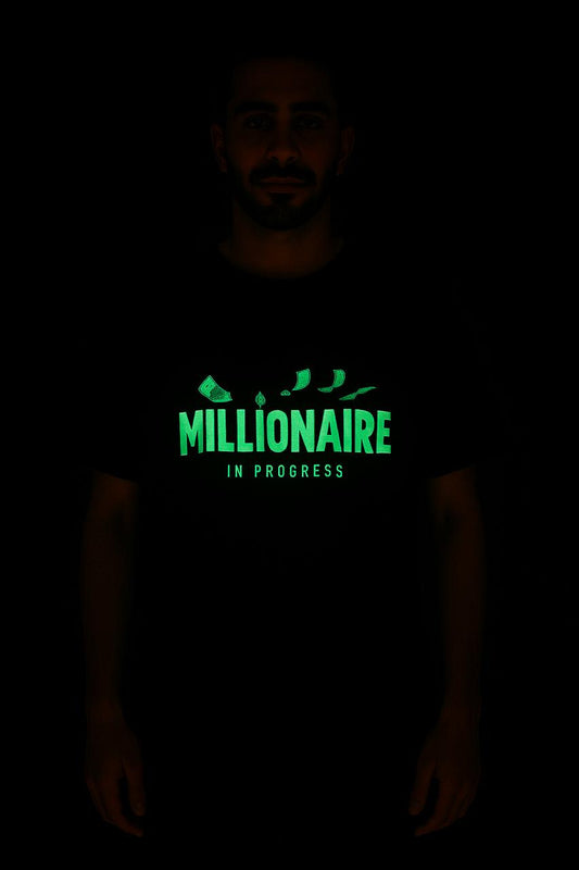 Glow-in-the-dark millionaire in progress tee with green illuminated text and money graphics