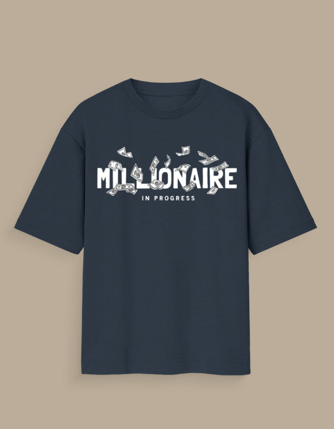 Navy blue millionaire in progress tee with white text and dollar bills graphic on front