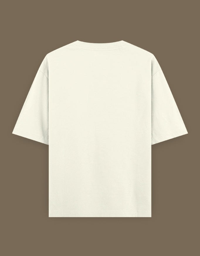 Back view of cream oversized Bachira anime t-shirt on brown background showing short sleeves and relaxed fit