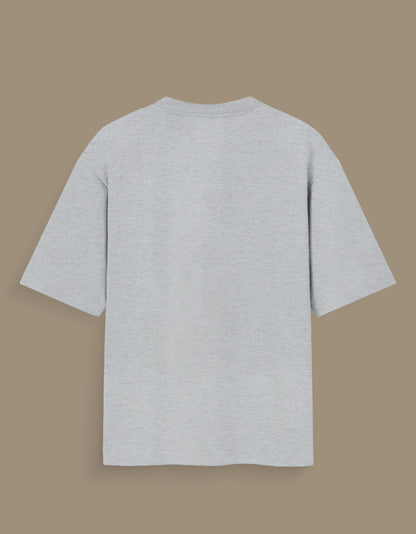 Plain light gray personalized oversized T-shirt India with short sleeves displayed on brown background