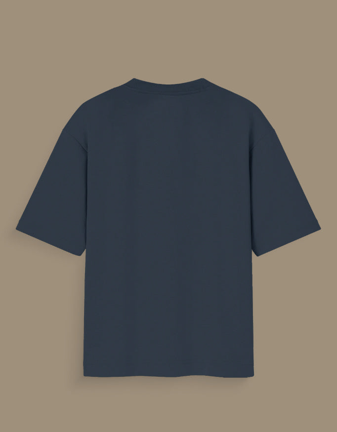 Back view of a plain dark gray personalized oversized T-shirt India displayed on purple background