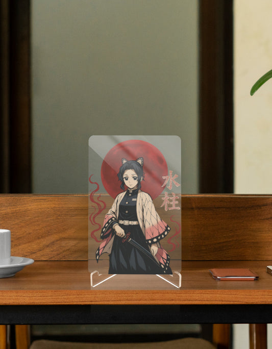 Shinobu anime relic displayed on a wooden table with a cup and a phone beside it