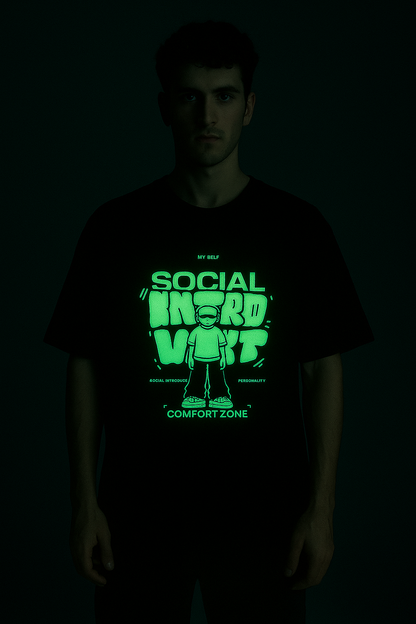 Social Introvert glow in the dark t-shirt with neon graphic design worn by a male model in dark